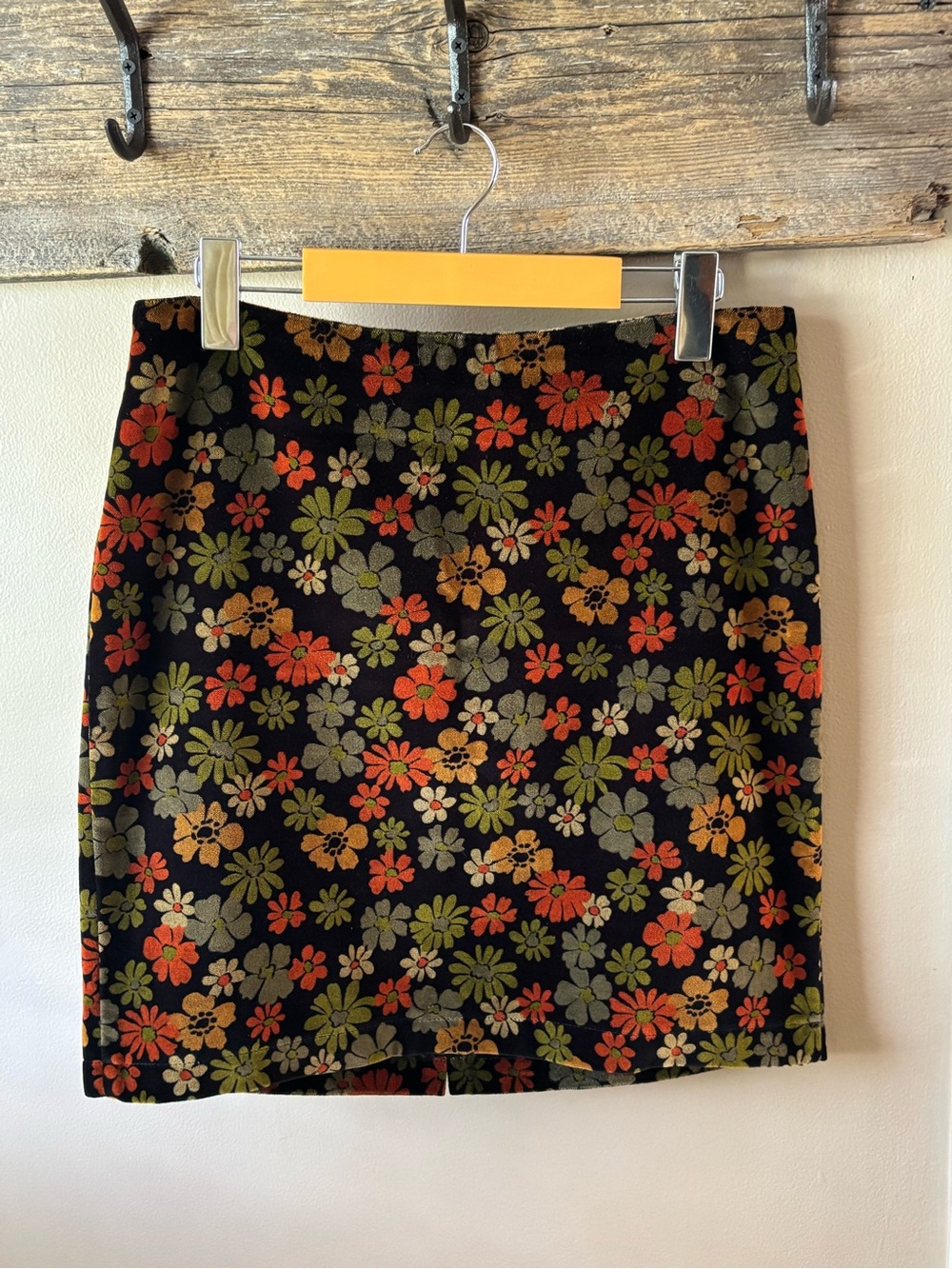 the clothing company Black Mini Skirt with Orange & Green Floral Print
